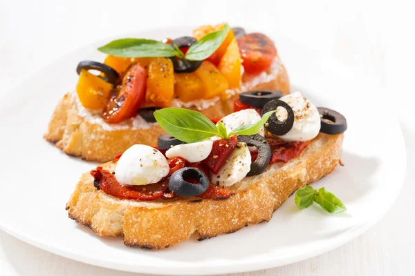 Italian appetizer - bruschetta on plate — Stock Photo, Image