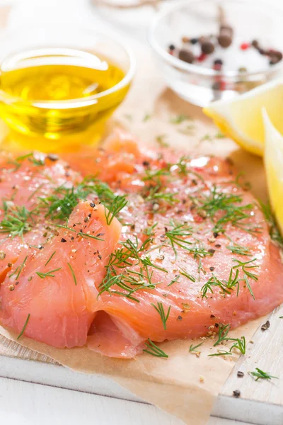 Salted salmon with dill on a wooden board, close-up — Stock Photo, Image