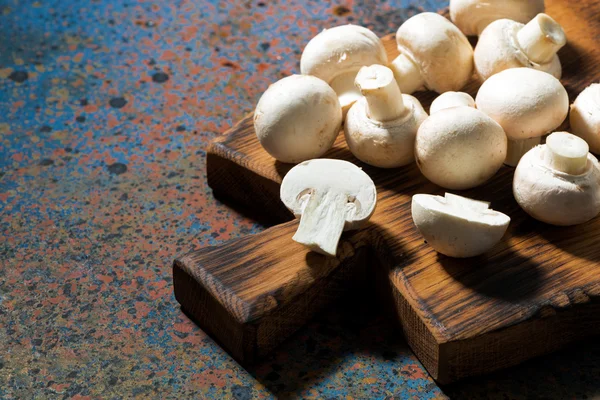 fresh organic mushrooms on vintage cutting board