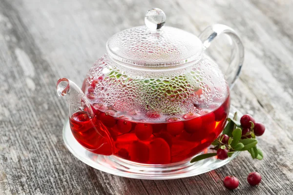 Berry tea in teapot on wooden table — Stock Photo, Image