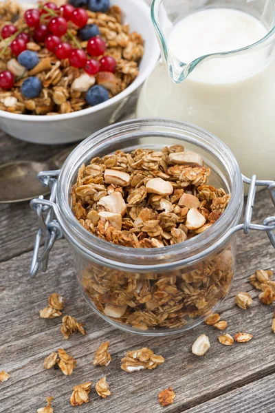 Jar with homemade granola, milk and fresh berries, vertical — Stock Photo, Image