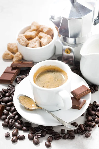 Tasse Espresso, Kaffeebohnen und Süßigkeiten, vertikal — Stockfoto