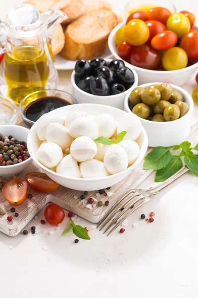 Fresh ingredients for salad with mozzarella on white table — Stock Photo, Image