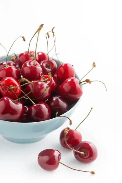 Bowl of fresh cherries on a white background, vertical — Stock Photo, Image