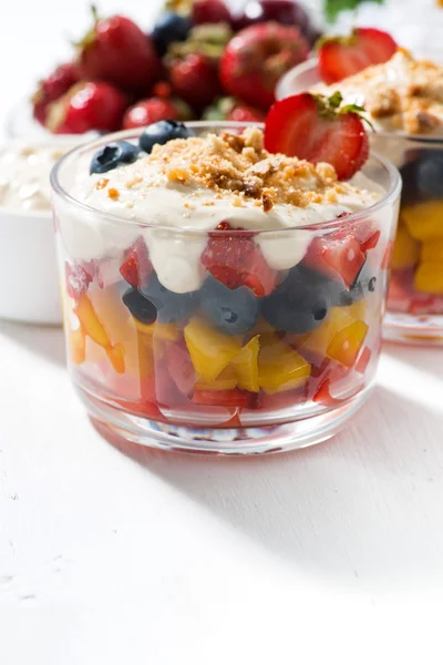 Assorted fresh fruit with custard on white table, closeup — Stock Photo, Image