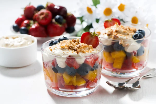 Assorted fresh fruit with custard on white table, closeup — Stock Photo, Image