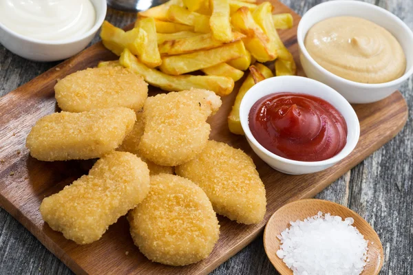 Chicken nuggets with french fries and different sauces — Stock Photo, Image