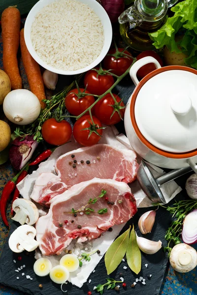 Two pieces of raw pork and fresh ingredients for soup, top view — Stock Photo, Image