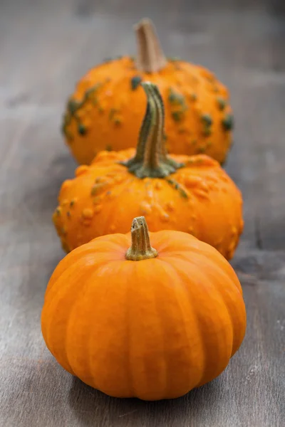 Orange pumpkins on a wooden background — Stock Photo, Image