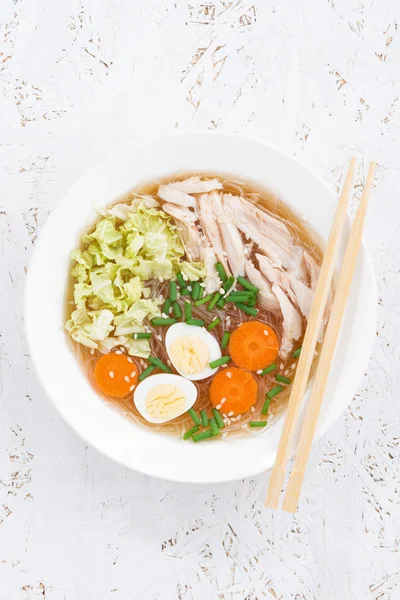 Bowl of Chinese soup with glass noodles, top view, vertical — Stock Photo, Image