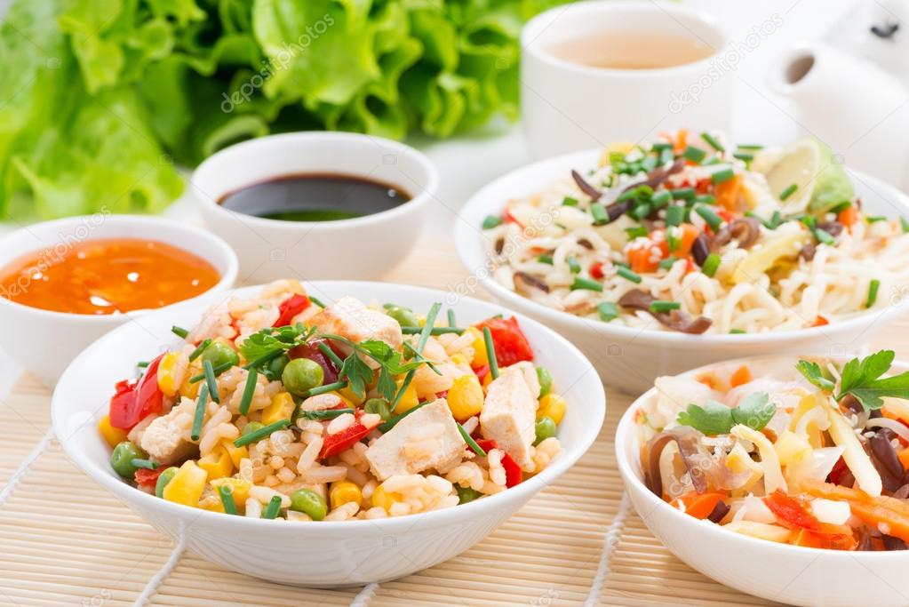 Asian food - fried rice with tofu, noodles with vegetables 