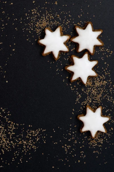Fundo preto com um pão de gengibre na forma de estrelas — Fotografia de Stock