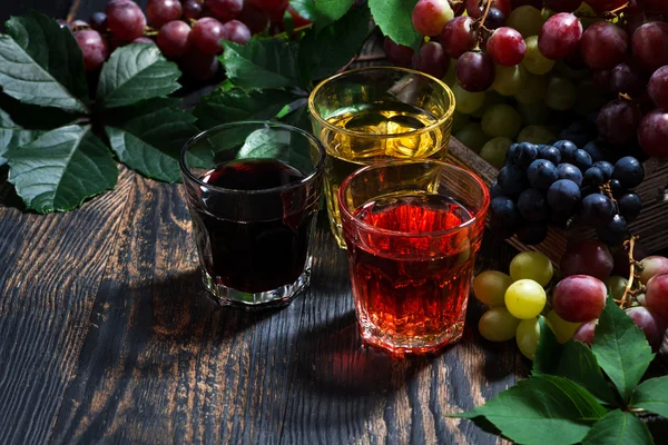 Assortment of grape juice on wooden background — Stock Photo, Image