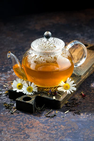 Chamomile tea in a glass teapot, vertical — Stock Photo, Image
