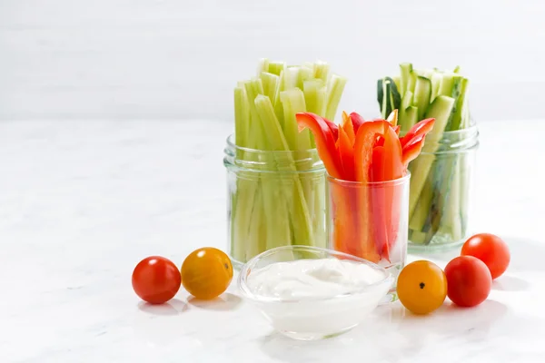 Healthy snacks, mixed vegetables and yogurt on a white table — Stock Photo, Image