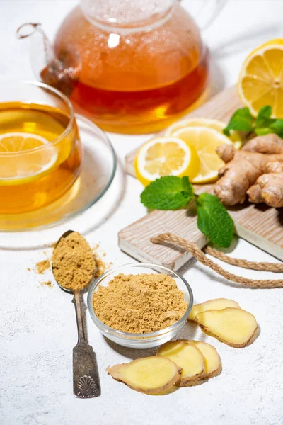 ingredients for tea for immunity - ginger, lemon and mint, vertical closeup