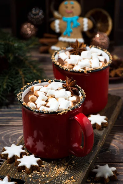 cozy winter drink hot chocolate in red mugs on wooden table, top view vertical