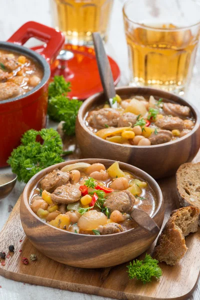 Delicious vegetable stew with sausages in wooden bowl, vertical — Stock Photo, Image