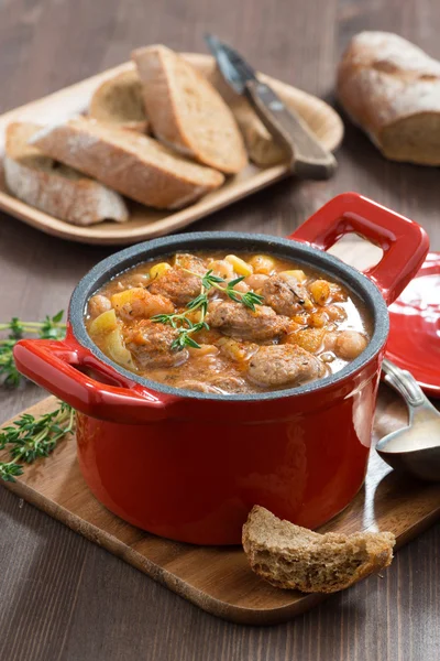 Delicious vegetable stew with sausages in a pan, vertical — Stock Photo, Image
