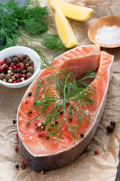 Raw salmon steak, lemon and spices prepared for cooking — Stock Photo, Image