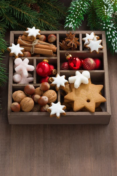 Box with Christmas symbols on a wooden table, vertical — Stock Photo, Image