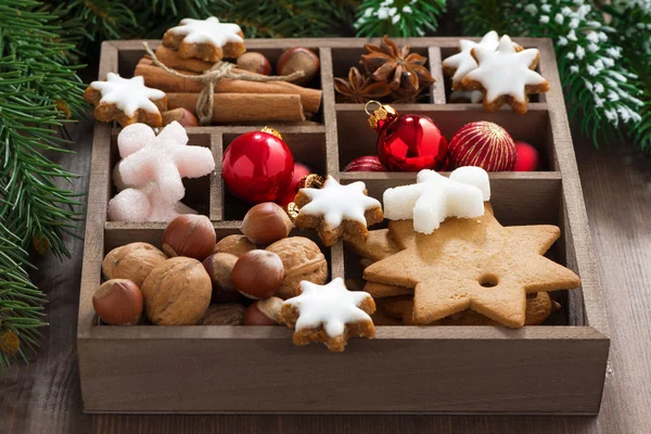 Box with Christmas symbols on a wooden table — Stock Photo, Image