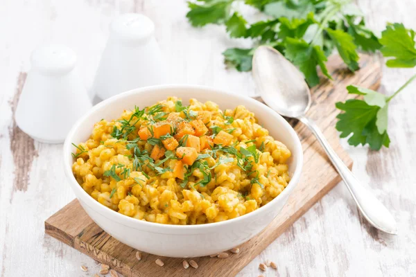 Barley porridge with pumpkin and greens in a bowl, horizontal — Stock Photo, Image