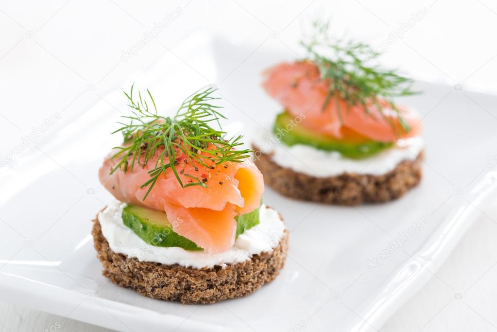 canape with cheese, cucumber and salmon