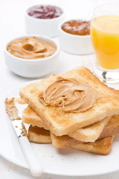 Toast with various jams and peanut butter, orange juice — Stock Photo, Image