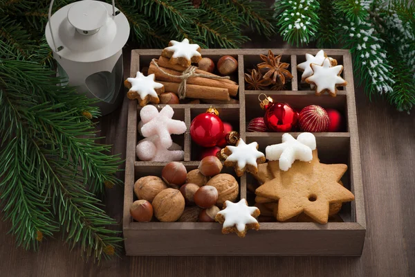 Wooden box with Christmas symbols and spruce branches — Stock Photo, Image