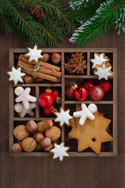 Wooden box with Christmas symbols and spruce branches, top view — Stock Photo, Image