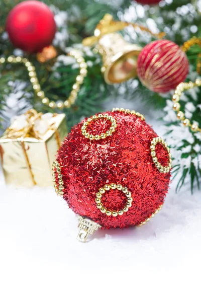 Red Christmas ball with fir branches and decorations — Stock Photo, Image