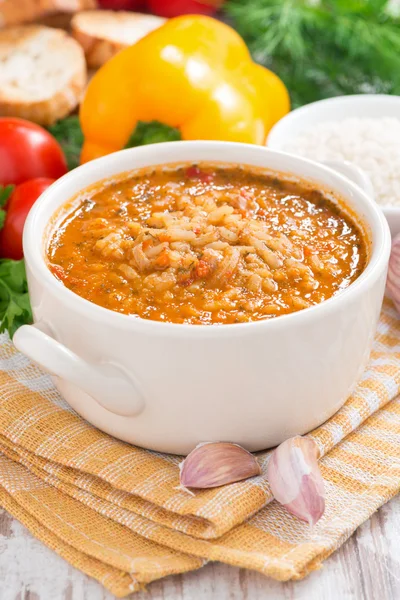 Tomato soup with rice and vegetables in a white saucepan — Stock Photo, Image