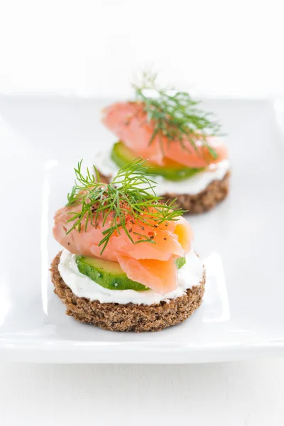 Canape with cheese, cucumber and salted salmon, vertical — Stock Photo, Image