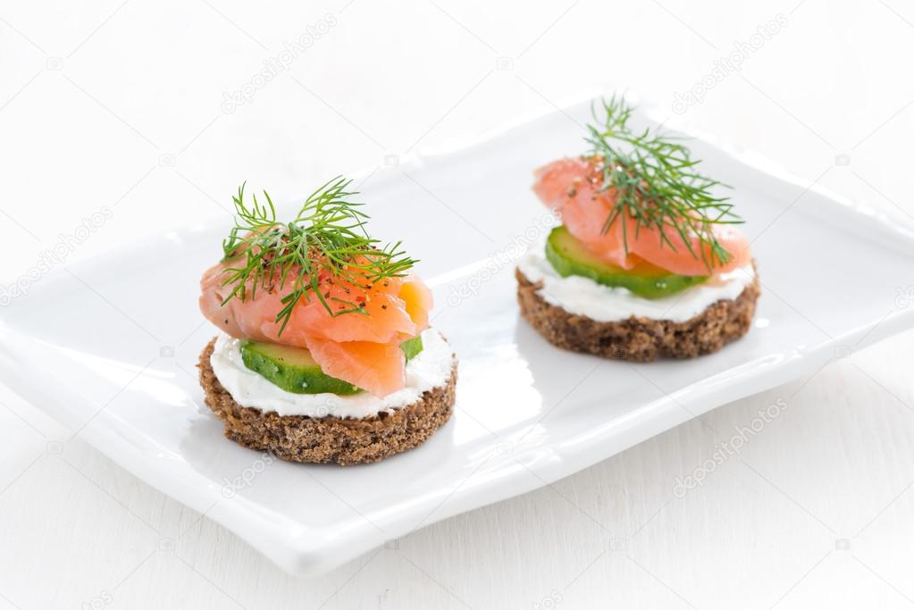 canape with cheese, cucumber and salted salmon