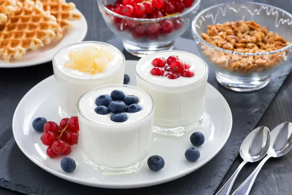 Assortment yogurt with fresh berries and waffles for breakfast — Stock Photo, Image