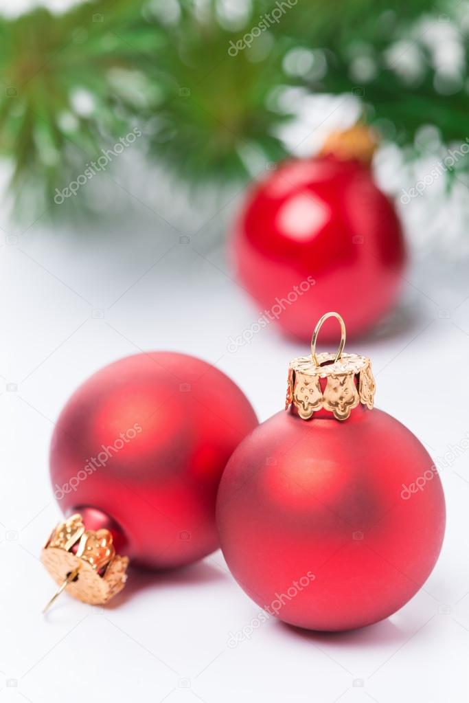 red Christmas balls on a white background, selective focus
