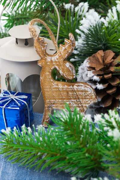 Christmas wooden ornaments and fir branches — Stock Photo, Image