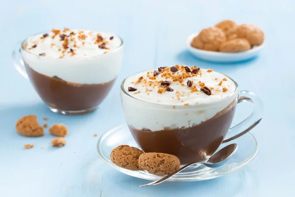 Dessert with chocolate, cream and amaretti on a blue table — Stock Photo, Image