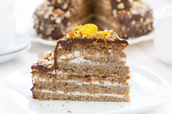 Piece of cake with chocolate cream and nuts, close-up — Stock Photo, Image