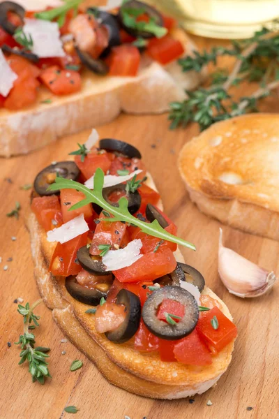 Ciabatta with tomatoes, olives, parmesan cheese and herbs — Stock Photo, Image