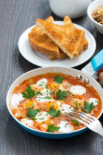 Fried quail eggs in tomato sauce and toasts, vertical — Stock Photo, Image