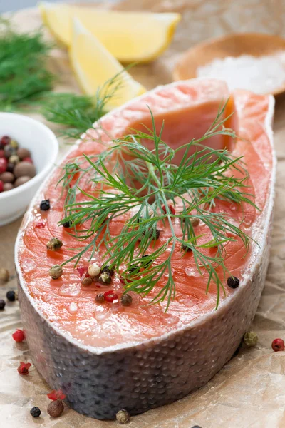 Fresh salmon steak, lemon and spices prepared for cooking — Stock Photo, Image