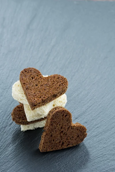 Festive appetizer - toasts in heart shape — Stock Photo, Image