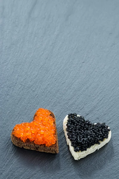 Toast con caviale rosso e nero nella forma di cuore — Foto Stock