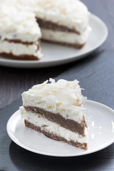 Piece of chocolate cake with coconut cream, vertical — Stock Photo, Image