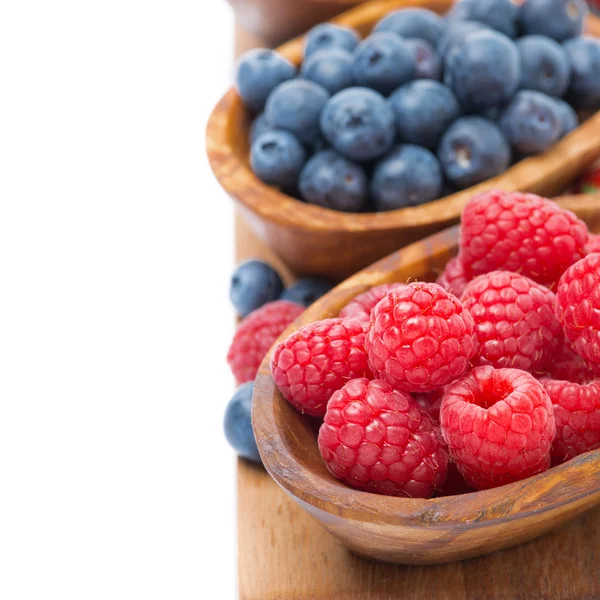 Assortment of fresh ripe berries in a wooden bowls, isolated — Stock Photo, Image