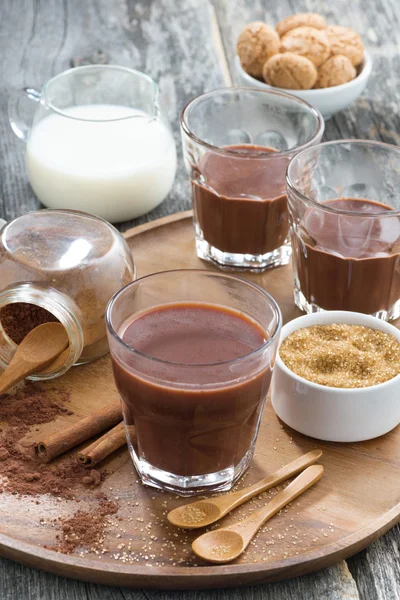 Cocoa in a glass on a wooden tray, vertical — Stock Photo, Image