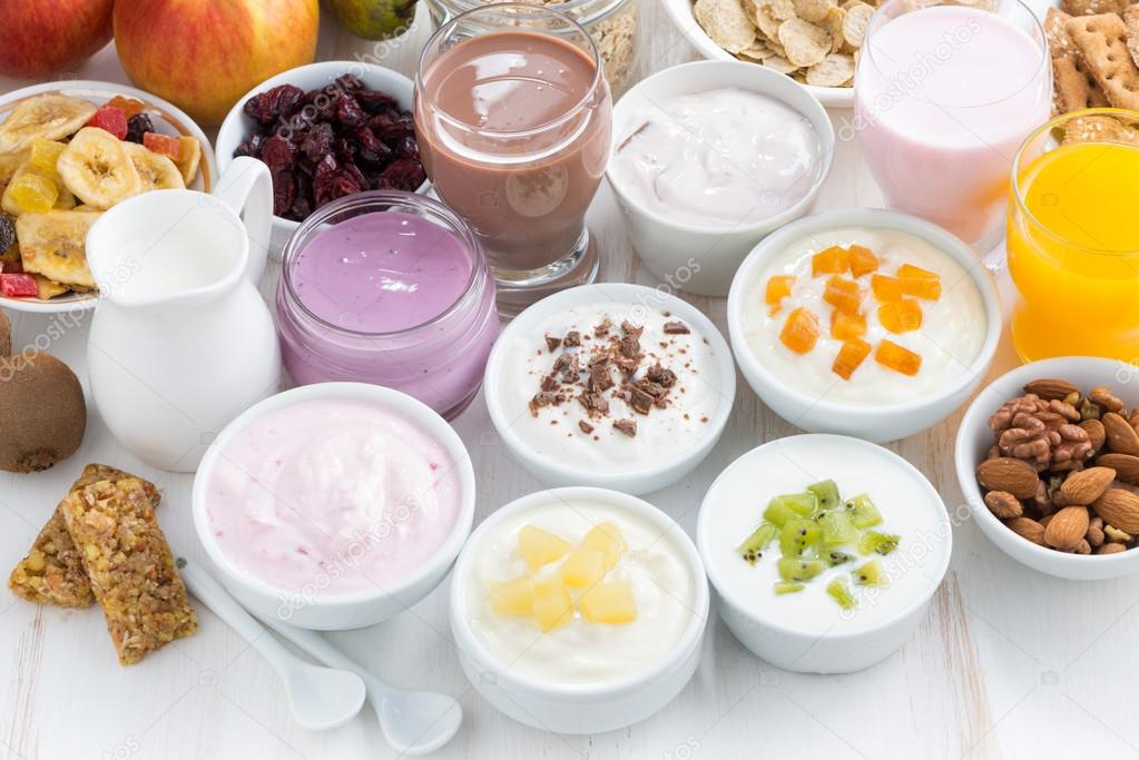 Assorted fresh fruit yoghurts and breakfast ingredients