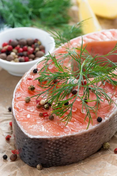 Raw salmon steak, lemon and spices prepared for cooking, closeup — Stock Photo, Image